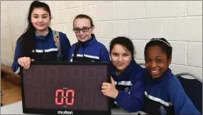  ??  ?? Tralee Primary CBS pupils keeping time on the exciting action at the John Mitchel’s on Friday - scene of the Kerry Primary Schools Hoop Tournament.