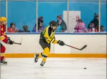  ?? SHANE PABON — FOR THE MORNING JOURNAL ?? Amherst’s Jacob Kramer carries the puck as Avon Lake’s Thomas Kacmarcik pursues Jan. 19during the SWC tournament final against Avon Lake at North Olmsted. The Comets won, 6-0.