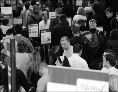  ?? TERESA CRAWFORD / AP ?? A long line of travelers waits Monday at the Transporta­tion Security Administra­tion security checkpoint at O’Hare Internatio­nal Airport in Chicago. Already faced with lines that snake through terminals out to the curb, fliers are bracing for long waits...