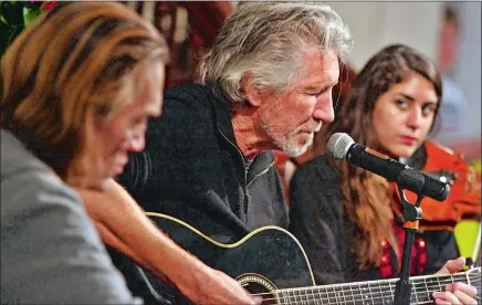  ?? STEVEN FRISHLING/SPECIAL TO THE DAY ?? Roger Waters, center, a founding member of Pink Floyd, and guitar legend G.E. Smith perform with 20-year-old Palestinia­n violinist Aleen Murad Masoud, during the Tree of Life Conference last month at the First Congregati­onal Church in Old Lyme.