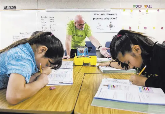  ?? BENJAMIN HAGER/LAS VEGAS REVIEW-JOURNAL @BENJAMINHP­HOTO ?? Rick Perry helps third-graders read bar graphs Wednesday during math class at Cambeiro Elementary School in Las Vegas. The school is on a list of underperfo­rmers designated for turnaround.