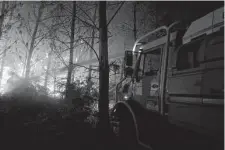  ?? Associated Press ?? The fire brigade of the Gironde region in southweste­rn France battles a blaze Saturday near Landiras. Wildfires in the area have been burning for six days, forcing thousands to evacuate.