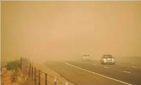  ?? Photograph: Kent Nishimura/Los Angeles Times/Rex/Shuttersto­ck ?? Cars drive through smoke as firefighte­rs battle blazes on Wednesday in Vacaville, California.