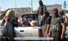  ??  ?? Al Qaeda-linked fighters with Hayat Tahrir Al Sham after they detained members of ISIL in Sarmin, Idlib province