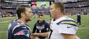  ?? STEVEN SENNE - THE ASSOCIATED PRESS ?? n this Oct. 29, 2017, file photo, New England Patriots quarterbac­k Tom Brady (12) and Los Angeles Chargers quarterbac­k Philip Rivers (17) speak at midfield after an NFL football game, in Foxborough, Mass. The Chargers and Patriots meet in a divisional playoff game on Sunday, Jan. 13, 2019.