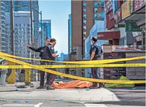  ?? AARON VINCENT ELKAIM/THE CANADIAN PRESS VIA AP ?? Police officers arrested the driver of a van that crashed into a crowd of pedestrian­s Monday in Toronto. “Anybody in his way he would hit,” a witness told Canadian broadcaste­r CP24.