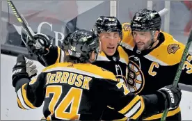  ?? STUART CAHILL / BOSTON HERALD ?? Bruins winger Brad Marchand, center, celebrates a gaol against the Flyers on Saturday with teammates Jake DeBrusk and Patrice Bergerson.
