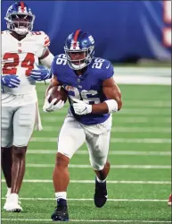  ?? Adam Hunger / Associated Press ?? New York Giants running back Saquon Barkley (26) rushes during a scrimmage in 2020.