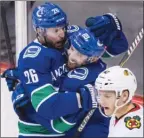  ?? The Canadian Press ?? Canucks forwards Thomas Vanek, left, and Sam Gagner celebrate Vanek’s goal in front of Chicago Blackhawks defenceman Gustav Forsling during second-period NHL action in Vancouver on Thursday night.