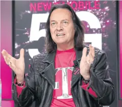  ?? AP ?? John Legere has fashioned himself a new kind of telecommun­ications executive. He made public appearance­s costumed in the bright magenta colour that T-Mobile uses to market itself.