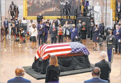  ?? Shawn Thew The Associated Press ?? House Speaker Nancy Pelosi of Calif., second from left with her back to the camera, attends a memorial service Monday as the casket of Rep. John Lewis, D-GA., lies in state at the Capitol Rotunda in Washington. Lewis died July 17 at the age of 80.