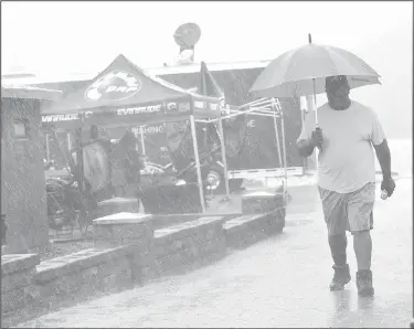  ?? NWA Democrat-Gazette/FLIP PUTTHOFF ?? Heavy rain falls before the FLW weigh-in Saturday at Prairie Creek park.