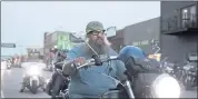  ?? STEPHEN GROVES — THE ASSOCIATED PRESS ?? Motorcycle­s cruised through downtown Sturgis, S.D., on Thursday. The Sturgis Motorcycle Rally began Friday, even as coronaviru­s cases rise in South Dakota.