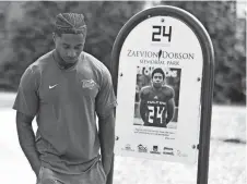  ?? ?? Former Middle Tennessee State football player Zack Dobson stops at the park named in honor of his brother, Zaevion Dobson, on March 25 in Knoxville, Tenn.