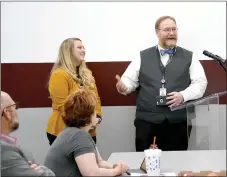  ?? Janelle Jessen/Siloam Sunday ?? Middle school principal Jacob Hayward (right) recognizes seventh grade English teacher Riley Ahern during Thursday’s school board meeting for receiving an Arvest We Love Teachers Award. Ahern is a new teacher this year who was nominated in October by a peer or student for the award, Hayward said. She is one of 131 teachers chosen for the award and will receive $500 for classroom supplies.