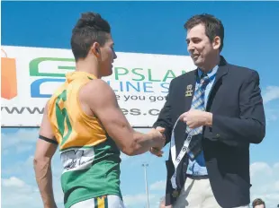  ??  ?? Right: Garfield’s Damion Denysenko receives the best on ground medal from Ellinbank District Football League board director Gerard Bongiorno