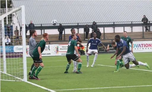  ?? Chelsie Wilson ?? Ekow Coker heads home Macclesfie­ld’s fourth goal against Burscough