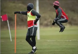  ?? NATHAN DENETTE, THE CANADIAN PRESS ?? TFC forwards Jozy Altidore, left, and Sebastian Giovinco keep warm up during practice.