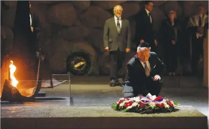  ?? (Amir Cohen/Reuters) ?? SLOVAKIAN PRESIDENT Andrej Kiska lays a wreath in the Hall of Remembranc­e at Yad Vashem in Jerusalem yesterday.