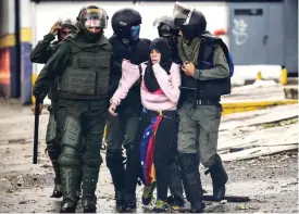  ??  ?? CARACAS: An anti-government activist is arrested during clashes. — AFP