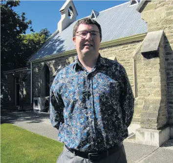  ?? PHOTO: PAM JONES ?? A life of faith . . . Alexandra/Clyde/Lauder Union Parish Presbyteri­an minister Andrew Howley stands next to St Enoch’s Church in Alexandra.