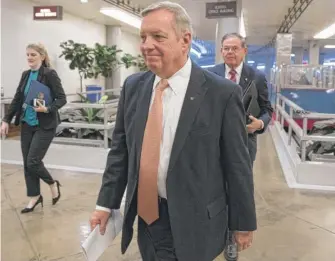  ??  ?? Sen. Dick Durbin, D- Ill., followed by Sen. Bob Menendez, D- N. J., walks in the Capitol as Congress moved closer to the deadline to avoid a government shutdown on Thursday.| J. SCOTT APPLEWHITE/ AP