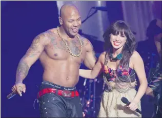  ?? CHRIS YOUNG/ CP ?? Flo Rida and Carly Rae Jepsen embrace after performing during the awards show.