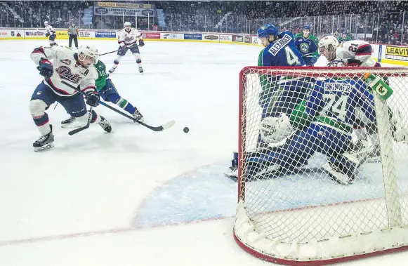  ?? BRANDON HARDER ?? The Regina Pats’ Jake Leschyshyn, left, fires a shot past Swift Current Broncos goaltender Stuart Skinner during Saturday’s WHL playoff game at the Brandt Centre.