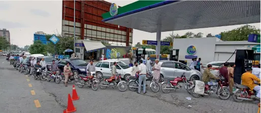  ?? AP ?? Motorcycle­s and cars stand in a long queue for fuel at a fuel station in Islamabad on Wednesday. —