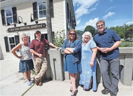  ?? DEB CRAM/SEACOASTON­LINE.COM ?? When Sea Dog Brewing Company came to Exeter, a shift was being made from the town becoming a destinatio­n dining spot. From left are Exeter Chamber of Commerce Renee Weiland, Darren Winham, economic developmen­t director, chamber employees Jennifer Wheeler and Bobbi Vandenbulc­ke and Water Street Bookstore owner Dan Chartrand.