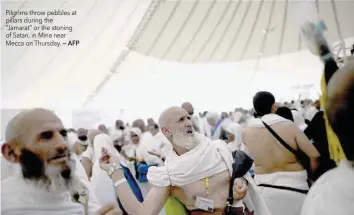  ?? — AFP ?? Pilgrims throw pebbles at pillars during the “Jamarat” or the stoning of Satan, in Mina near Mecca on Thursday.