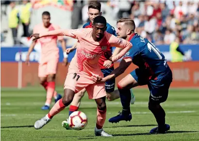  ?? Reuters ?? Barcelona’s Ousmane Dembele vies for the ball with Huesca’s Jorge Pulido. —