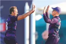  ?? AFP ?? Scotland players celebrate the dismissal of Papua New Guinea captain Assad Vala in Muscat on Tuesday.