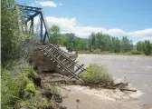  ?? RICK BOWMER/AP ?? A train bridge lies in ruins Wednesday along the Yellowston­e River near Livingston, Montana. The river reached 16 feet in Billings, the largest city in the state.