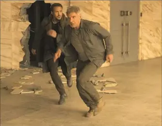  ??  ?? Ryan Gosling, left, and Harrison Ford in “Blade Runner 2049.”