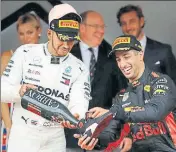  ?? REUTERS ?? Red Bull’s Daniel Ricciardo, winner of Monaco GP, with thirdplace­d Lewis Hamilton.