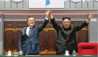  ?? / Associated Press ?? South Korean President Moon Jae-in and North Korean leader Kim Jong Un are all smiles after watching a gymnastic and artistic performanc­e Wednesday at May Day Stadium in Pyongyang.