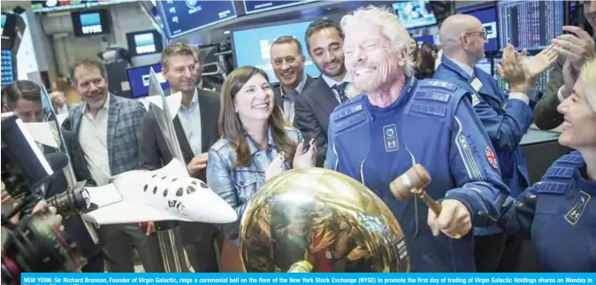  ??  ?? NEW YORK: Sir Richard Branson, Founder of Virgin Galactic, rings a ceremonial bell on the floor of the New York Stock Exchange (NYSE) to promote the first day of trading of Virgin Galactic Holdings shares on Monday in New York City. — AFP