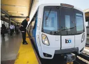  ?? Michael Macor / The Chronicle ?? Veteran BART train operator Kirk Paulsen peers into one of the new test cars back in July.