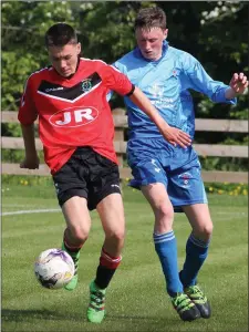  ??  ?? Ciarán Kavanagh of Bunclody breaks away from Jack White (North End United) in the Under-16 Cup final.