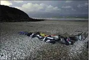  ?? RAFAEL YAGHOBZADE­H / AP ?? Life jackets, sleeping bags and damaged inflatable small boat are pictured on the shore in Wimereux, northern France, Friday.