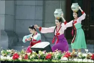  ?? AP PHOTO/CHA SONG HO ?? An art troupe performs in front of the Pyongyang Grand Theatre in Pyongyang, North Korea, Tuesday, July 27, 2021, to mark the Korean War armistice anniversar­y. The leaders of North and South Korea restored suspended communicat­ion channels between them and agreed to improve ties, both government­s said Tuesday, amid a 2½ year-stalemate in U.s.-led diplomacy aimed at stripping North Korea of its nuclear weapons.