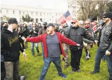  ?? Noah Berger / Special to The Chronicle ?? A man tries to separate protesters and President Trump supporters at a March 4 rally in Berkeley that ended in violence.