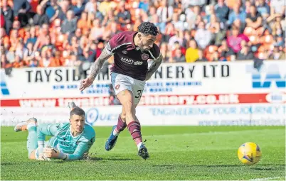  ?? ?? Benjamin Siegrist can only look on as Josh Ginnelly scores Hearts’ second goal at Tannadice.