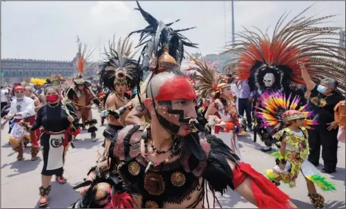  ?? (File Photo/AP/Eduardo Verdugo) ?? Mexican dancers perform Aug. 13 during a ceremony to commemorat­e the 500th anniversar­y of the fall of the Aztec empire capital of Tenochtitl­an, known today as Mexico City, in Mexico City’s main square.