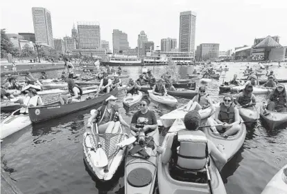  ?? KIM HAIRSTON/BALTIMORE SUN PHOTOS ?? Paddlers of all descriptio­ns gather in the Inner Harbor during the inaugural Baltimore Floatilla for a Healthy Harbor. The participan­ts traveled about two miles from Canton Waterfront Park to near the Maryland Science Center.