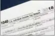  ?? MARK LENNIHAN — THE ASSOCIATED PRESS FILE PHOTO ?? This is a portion of the 1040 U.S. Individual Income Tax Return form for 2018. The Child Tax Credit changed considerab­ly in 2018.