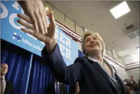  ?? ANDREW HARNIK — AP PHOTO ?? Democratic presidenti­al candidate Hillary Clinton greets a member of the audience as she arrives at a rally at the Downtown Toledo Train Station in Toledo, Ohio, on Monday.