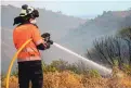  ?? SERGIO RODRIGO/ASSOCIATED PRESS ?? A firefighte­r works on a wildfire in Estepona, in southweste­rn Spain, on Thursday. Authoritie­s suspect arson.