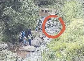  ??  ?? The body of Vaughn Carl Dicang was found in a creek in Barangay Balabac, Baguio City yesterday in this photo posted on Facebook by his brother Oliver Van.